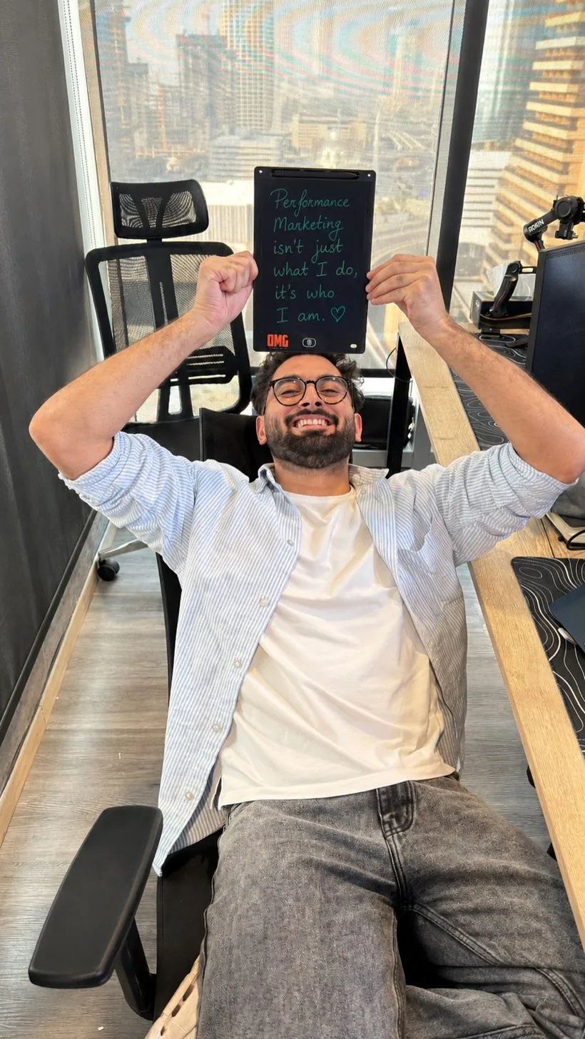 Abhishek Thakral, freelance performance marketer in Dubai, holding a tablet that reads: Performance marketing isn't just what I do, it's who I am.